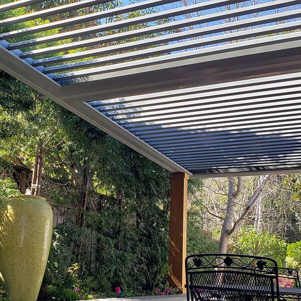 Custom outdoor shades using a louvered pergola in Kansas City.